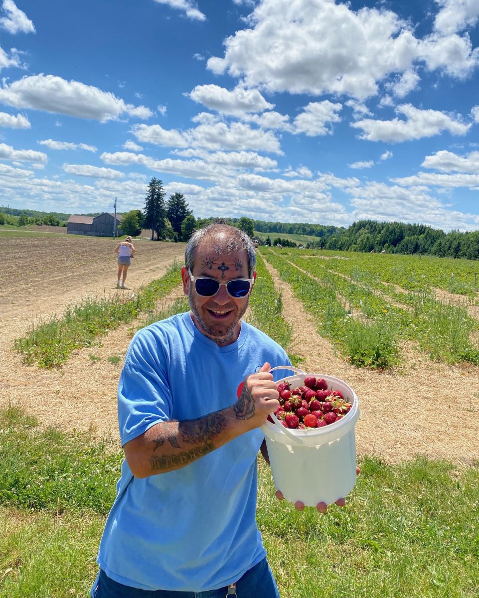 Mike shows off the fruits of his labor at the strawberry patch!